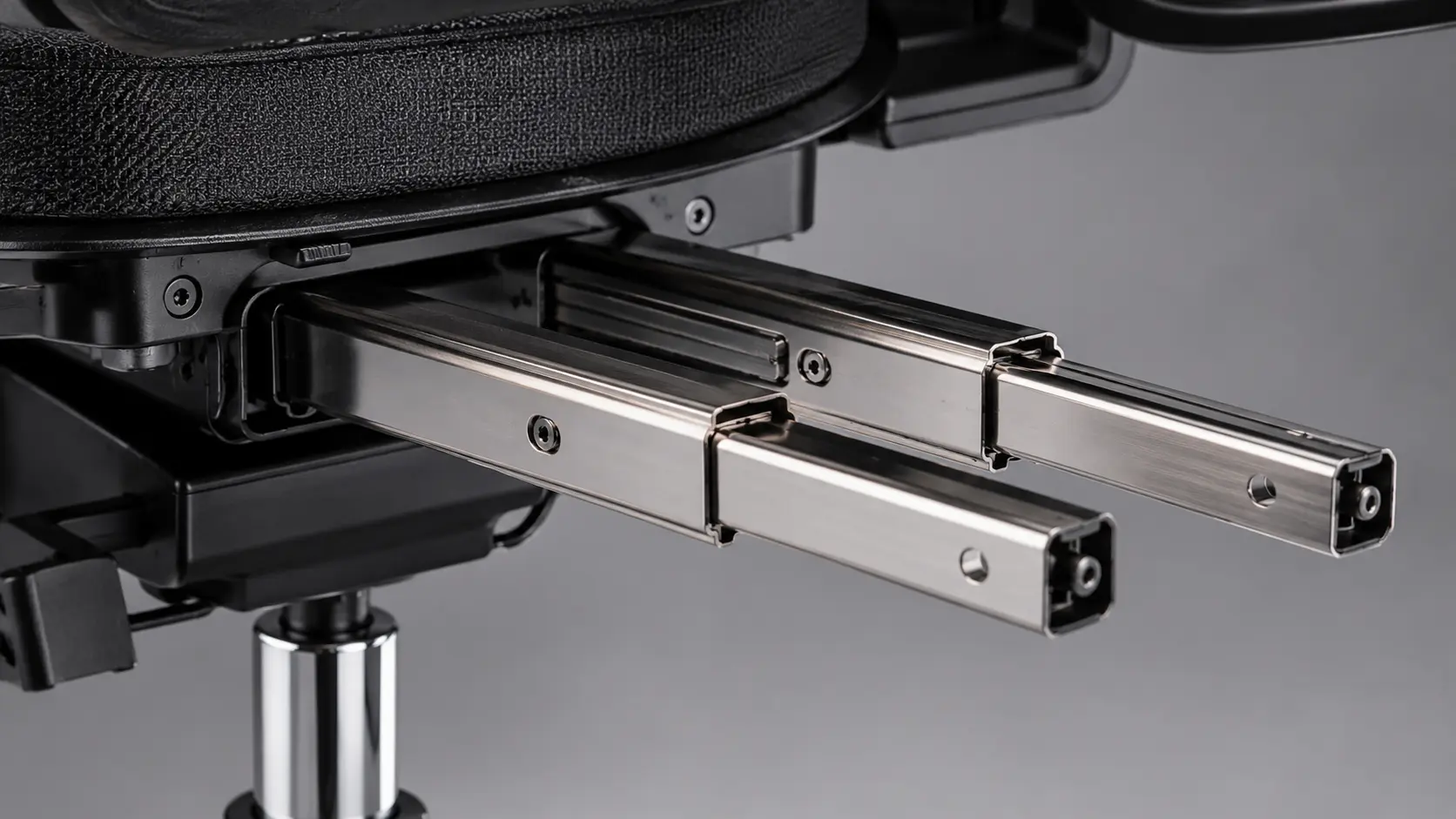Macro Industrial Product Shot of Dual Solid Stainless Steel Sliding Rails Mounted Securely Underneath an Ergonomic Chair Seat Pan